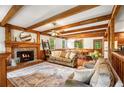 Inviting living room with a fireplace, exposed wood beams, and a cozy seating area at 258 Lancaster Cir, Marietta, GA 30066