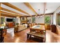 Open-concept living space with wood floors, dining area, exposed beams, and a cozy seating area at 258 Lancaster Cir, Marietta, GA 30066
