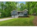 Charming two-story home features a covered porch, two-car garage, and lovely landscaped front yard at 76 Hollis Cir, Dallas, GA 30157