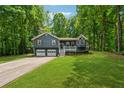 Charming two-story home features a covered porch, two-car garage, and lovely landscaped front yard at 76 Hollis Cir, Dallas, GA 30157