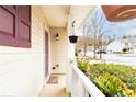 Inviting front porch adorned with lush plants and a hanging flower basket for added curb appeal at 176 Darbys Crossing Ct, Hiram, GA 30141