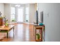 Bright living room with hardwood floors, a flat-screen TV, and a view of the outdoors at 176 Darbys Crossing Ct, Hiram, GA 30141