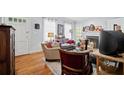 Cozy living room featuring hardwood floors, a fireplace, comfortable seating, and abundant natural light at 1941 Headland Dr, East Point, GA 30344