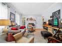 Bright living room boasts large windows, a fireplace, neutral tones, and stylish decor for relaxation at 1941 Headland Dr, East Point, GA 30344