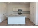 Bright kitchen with granite countertops, stainless steel appliances, and a central island at 2093 Boxwood Se Cir, Conyers, GA 30094