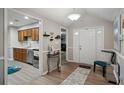 Inviting entryway with stylish decor, chair, and a view into the kitchen featuring modern appliances at 161 Brookfield Dr, Stockbridge, GA 30281