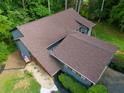 An overhead view of the home's brown roof and a manicured lawn at 2674 Skylane Dr, Marietta, GA 30062