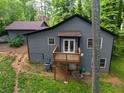 Home's backyard boasts a small deck, gray siding, and lush greenery at 2674 Skylane Dr, Marietta, GA 30062