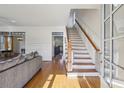Bright foyer with hardwood floors, staircase, and natural light creates an inviting entryway to the home at 976 Arthur Nw Ln, Atlanta, GA 30318