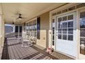 Inviting front porch with rocking chairs, ceiling fans, and ample natural light, perfect for relaxation and entertaining at 976 Arthur Nw Ln, Atlanta, GA 30318