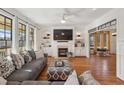 Cozy living room with fireplace, built-in shelving, hardwood floors, and large windows providing ample natural light at 976 Arthur Nw Ln, Atlanta, GA 30318