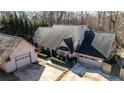 Aerial view of the house with a long driveway, landscaping, a two-car garage and another detached garage at 5479 Dorsett Shoals Rd, Douglasville, GA 30135