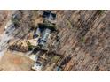 Aerial view of a property showcasing its layout, surrounding trees, and proximity to the road at 5479 Dorsett Shoals Rd, Douglasville, GA 30135