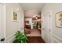 Welcoming foyer leads to living spaces, featuring hardwood floors and decorative accents at 692 Oakside Pl, Acworth, GA 30102
