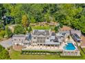 Aerial view of the estate showcasing the layout, pool, manicured grounds, and surrounding greenery at 1040 W Conway Nw Dr, Atlanta, GA 30327