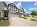 Inviting townhome boasting brick accents, a spacious two-car garage, and a neatly landscaped yard at 1312 Cooper Springs Rd, Grayson, GA 30017
