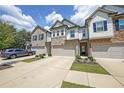 Attractive townhome featuring brick and siding with a two-car garage and lush landscaping enhancing the curb appeal at 1312 Cooper Springs Rd, Grayson, GA 30017