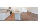 Kitchen view featuring white cabinets, a center island with granite counters, and stainless steel appliances at 1312 Cooper Springs Rd, Grayson, GA 30017