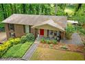 Brick home with a cozy front porch and well-maintained landscaping at 3517 Greenway Dr, Marietta, GA 30008