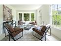 Cozy sitting area with large windows, stylish furniture, and a patterned rug at 4085 Chadds Walk, Marietta, GA 30062