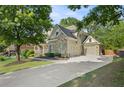 A two-car garage and driveway of a beautiful home with stone and siding exterior at 4731 Moon Chase Dr, Buford, GA 30519