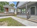 Charming gray house with a covered front porch and well-maintained landscaping at 558 Elbridge Nw Dr, Atlanta, GA 30318
