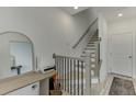 Bright stairway featuring wood-look floors, modern railings, and white walls at 1117 Larkin Dr, Buford, GA 30518