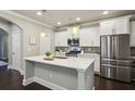 Modern kitchen featuring white cabinets, stainless steel appliances, and a center island at 2023 Yellow Finch Trl, Atlanta, GA 30316