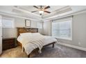 Serene main bedroom with tray ceilings, a wooden headboard, and neutral decor at 2023 Yellow Finch Trl, Atlanta, GA 30316