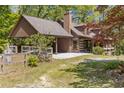 Exterior of a log home featuring an attached carport and well-maintained yard at 2377 Pine Mountain Rd, Kennesaw, GA 30152
