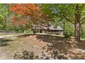 Beautiful log cabin-style home with a convenient carport and well-maintained yard in a wooded setting at 2377 Pine Mountain Rd, Kennesaw, GA 30152