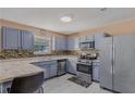 Functional kitchen with painted cabinets, tiled backsplash, stainless steel appliances, and ample counter space at 240 Creekview Blvd, Covington, GA 30016