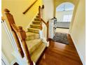 Staircase featuring carpeted steps and wooden railing leading to the upper level at 6156 Thorncrest Dr, Tucker, GA 30084