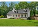 Charming home featuring a red front door, front porch and manicured front lawn at 831 Terrace Trce, Lawrenceville, GA 30044