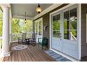 Relaxing porch featuring rocking chairs and a swing, with views of the lush surroundings at 10559 Serenbe Ln, Chattahoochee Hills, GA 30268