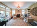 Elegant home office features a fireplace, large windows, and designer decor at 150 Shady Grove Ln, Alpharetta, GA 30009