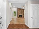 Inviting foyer view into a spacious living room with a stone fireplace and wood floors at 1360 Terramont Dr, Roswell, GA 30076