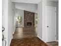 Open-concept living room featuring a stone fireplace and new hardwood floors at 1360 Terramount Dr, Roswell, GA 30076