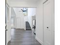 Bright foyer with high ceilings, hardwood floors, and staircase leading to upper level, creating an open and airy entrance at 234 Pam Sw Ln, Marietta, GA 30064