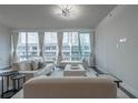A bright living room featuring neutral furnishings, hardwood floors, modern lighting, and city views at 20 10Th Nw St # 704, Atlanta, GA 30309