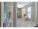 Bright foyer with elegant marble flooring, decorative columns, and staircase leading to the upper level at 988 Gentry Sw Ln, Marietta, GA 30064