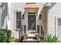 Charming home entrance with a black front door, copper awning, and well-maintained landscaping at 988 Gentry Sw Ln, Marietta, GA 30064