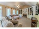 Cozy living room with a fireplace, built-in shelving, and large windows offering plenty of natural light at 988 Gentry Sw Ln, Marietta, GA 30064
