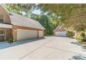 Long driveway leads to multiple garages on this lovely brick home at 1609 Holly Ridge Dr, Loganville, GA 30052