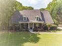 Charming one-story home with well-manicured lawn, landscaping and cozy front porch at 1609 Holly Ridge Dr, Loganville, GA 30052