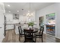 Eat-in kitchen featuring white cabinets, stainless steel appliances, and a view to the covered patio at 2580 Glaramara Ter, Cumming, GA 30041