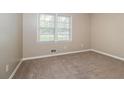 Neutral bedroom with carpet flooring, a window, and fresh paint ready for personalization at 2914 Landmark Se Dr, Conyers, GA 30094
