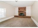 Spacious living room featuring a classic brick fireplace, neutral walls, and carpet at 2914 Landmark Se Dr, Conyers, GA 30094