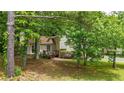 The inviting entrance is enhanced by a charming deck, framed by mature trees and natural landscaping at 3117 Calumet Nw Cir, Kennesaw, GA 30152