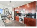 Well-lit kitchen boasts dark cabinets, granite countertops, and stainless steel appliances at 400 W Peachtree Nw St # 3801, Atlanta, GA 30308